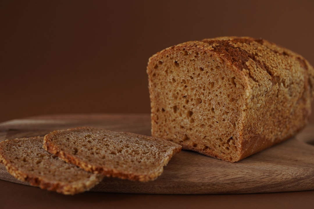 Bread loaf and slices on a wooden board.