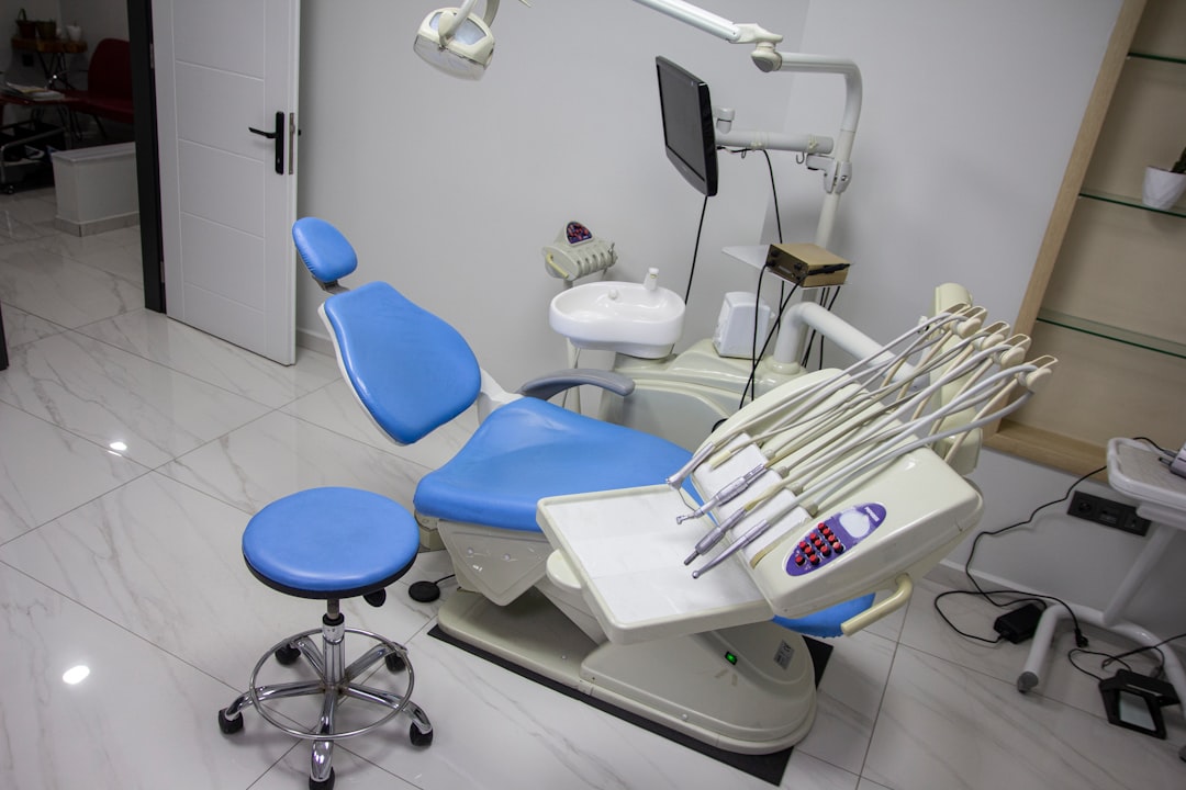a dental room with a blue chair and dental equipment