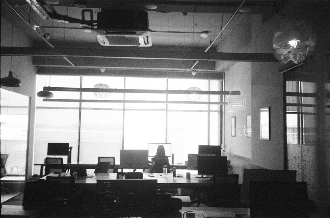 Modern office space with desks and computers near large window