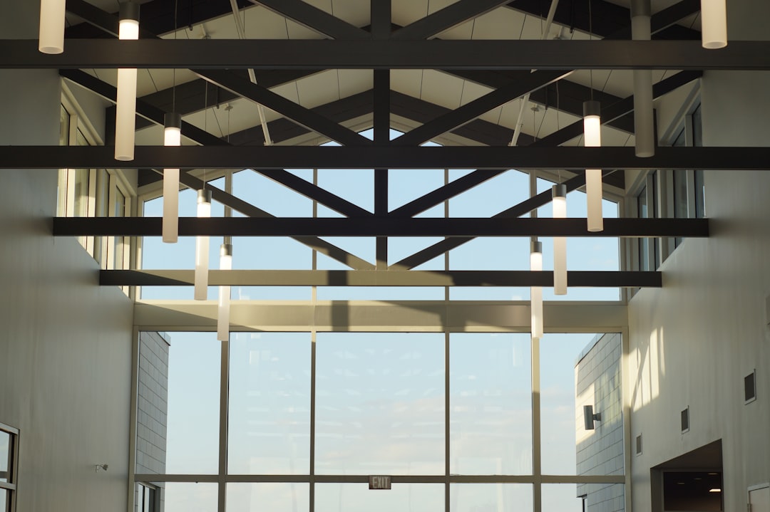 Modern building interior with skylights and glass walls.