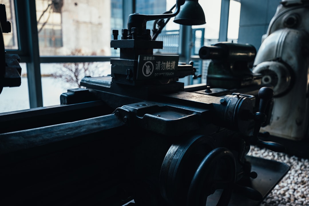 Close-up of an old metal lathe in a workshop.