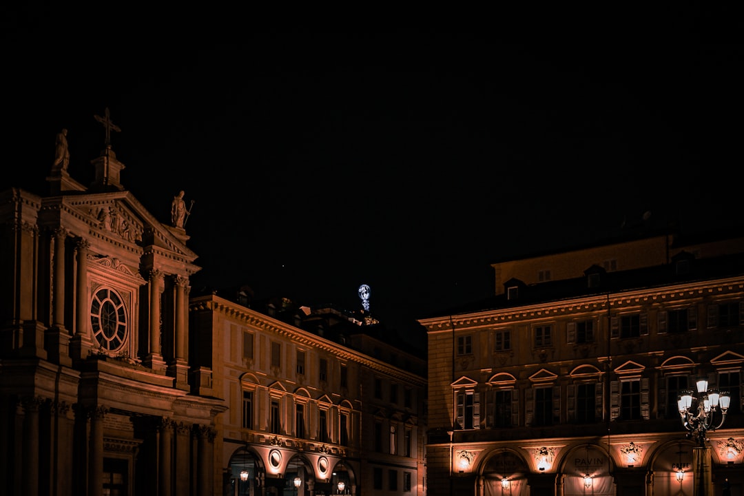 a city street at night with a clock tower in the background