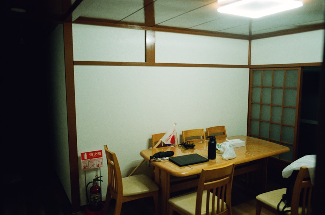 A dining table set with chairs in a room.