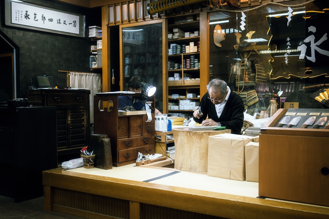 Elderly man working in a cluttered shop